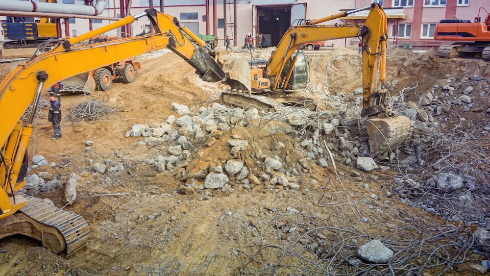 Powerful excavators dismantle concrete
